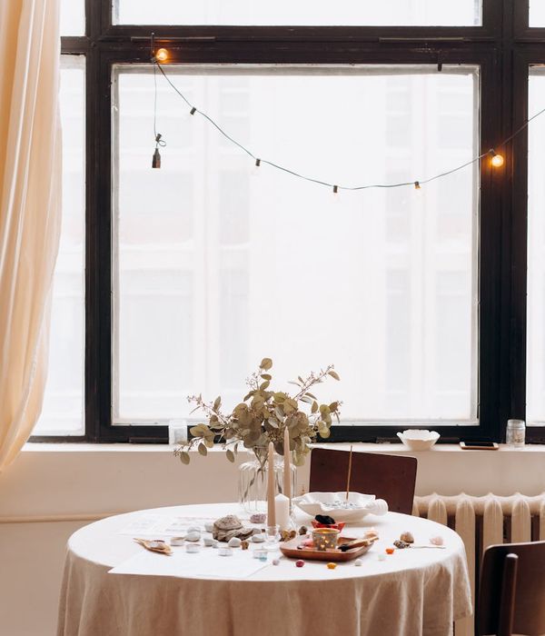 Woman in a calm yoga pose in a minimalist setting.